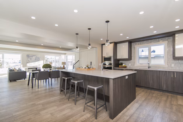 Modern Cape Town kitchen with white cabinetry, marble countertops, and pendant lighting.